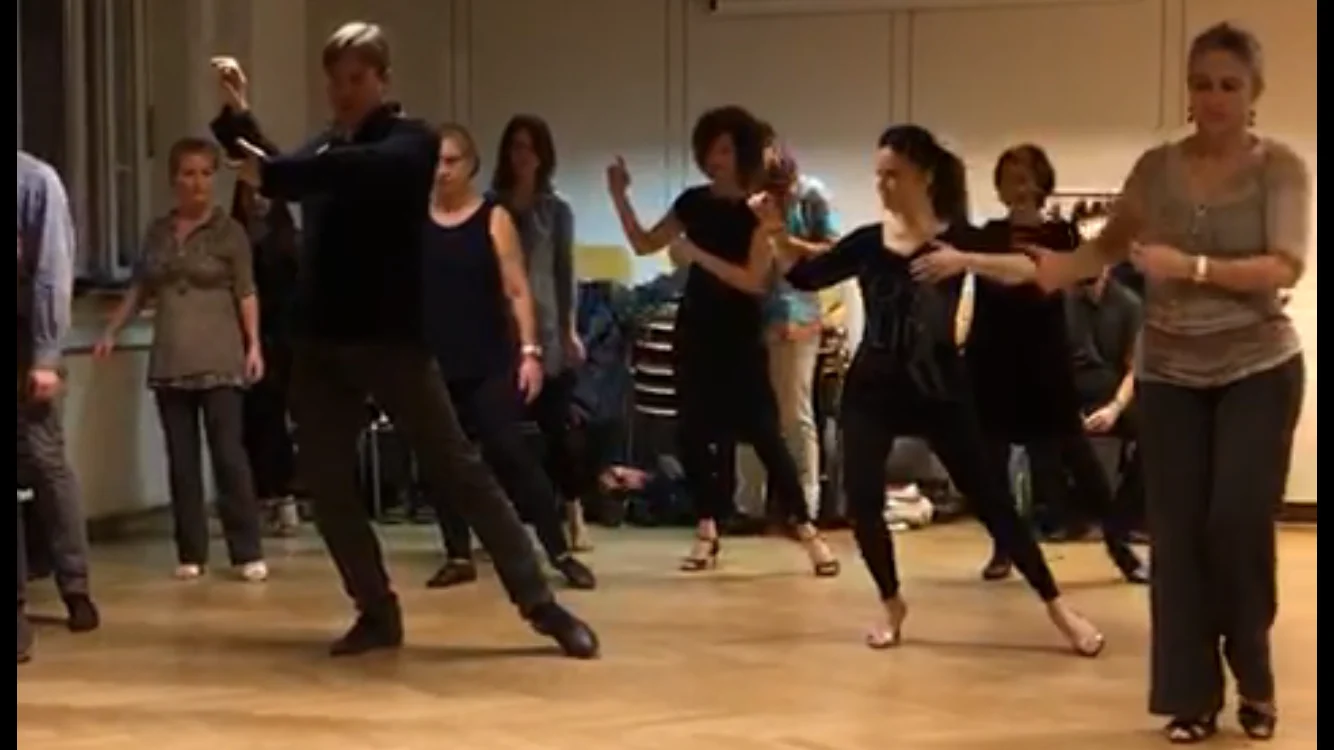 Shawn exploring a movement with a large group including many women