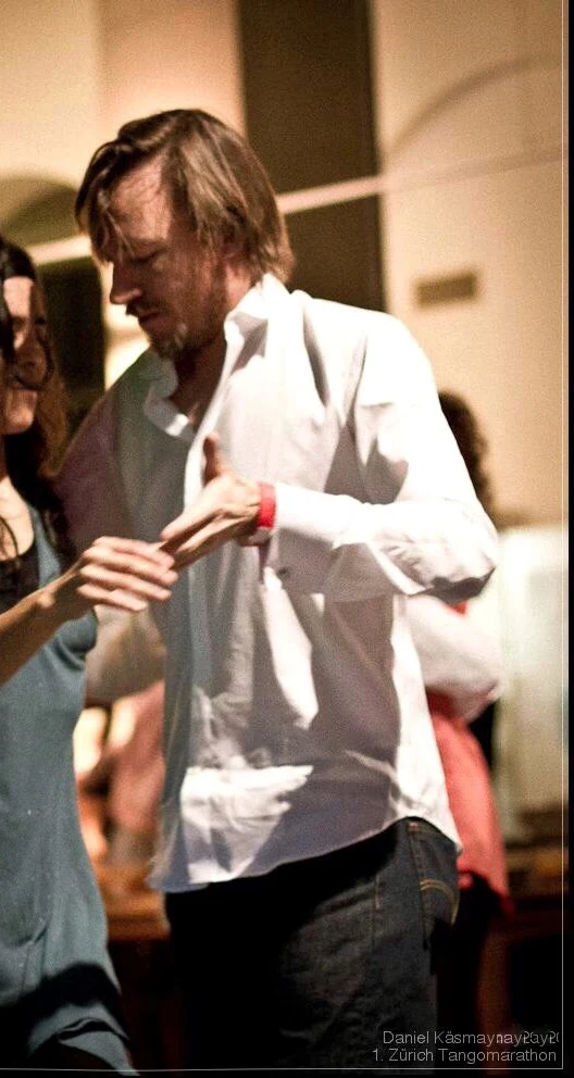 Closely cropped archive of Shawn dancing at the Zürich Tango Marathon, with his partner almost entirely outside the frame